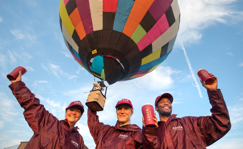 Costa Coffee team holding a balloon at Bristol International Balloon Fiesta